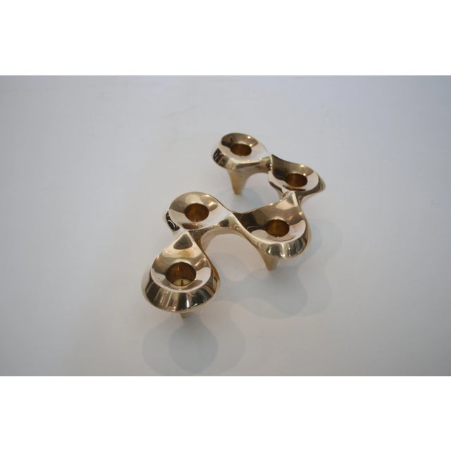 Retired edition of Jonathan Adler's brass undulating candelabra sold at Neiman Marcus. Each piece was hand sculpted in his...