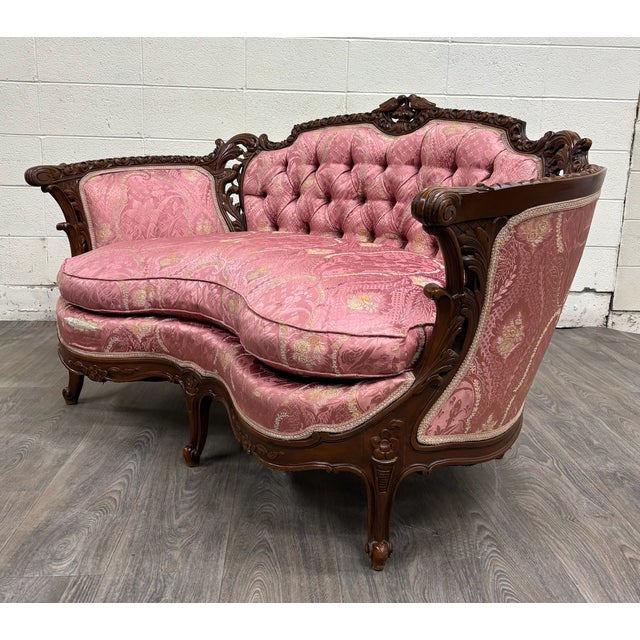 This is a gorgeous antique Victorian Rococo Revival or French Louis XV carved walnut loveseat or settee from the late 19th...