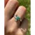 14k white gold ring mounts 5 round brilliant cut natural Emeralds of 0.30 carats and 0.07 carats in natural diamonds....