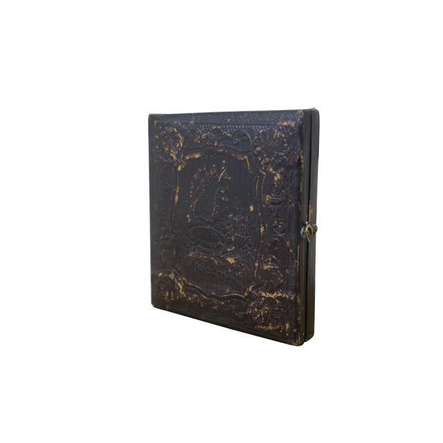 Antique, mid-1800s daguerreotype case, made of leather or gutta-percha, designed to hold an early photograph. The case...