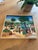 Fantastic late 20th century folk art painting featuring scenes from a Haitian village. The details on this piece are...