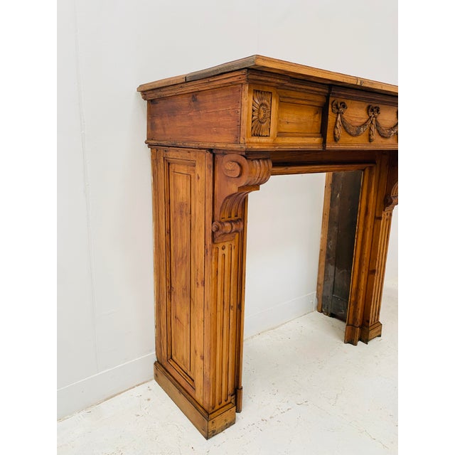Louis xvi style fir wood fireplace two corbelled jambs with recessed fluting carved pediment with ribboned knots good...