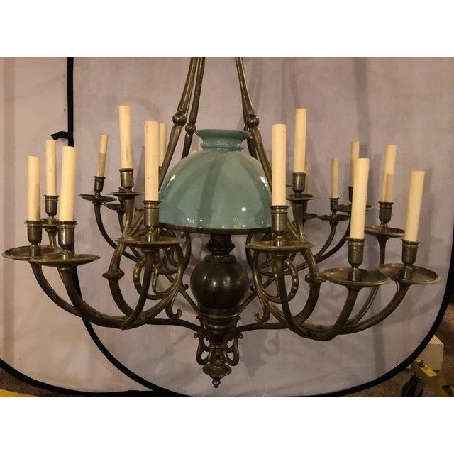 An early 1900s Georgian style chandelier with a globe centre matching chain and canopy. A wonderful bronze form twenty one...