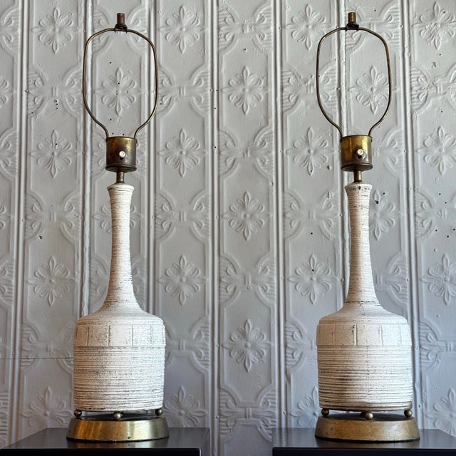 Perfect combination of aged brass details and white crackled finish on these MidCentury table lamps. Height to finial top...