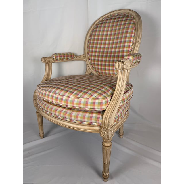 A handsome Louis XVI style carved Fauteuil armchair, featuring an oval upholstered back above a generously proportioned...