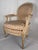 A handsome Louis XVI style carved Fauteuil armchair, featuring an oval upholstered back above a generously proportioned...