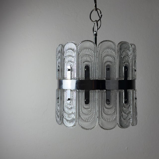 Mid-century crystal chandelier by kaiser leuchten. Made in germany in the 1960s. the lamp features a metal frame with a...