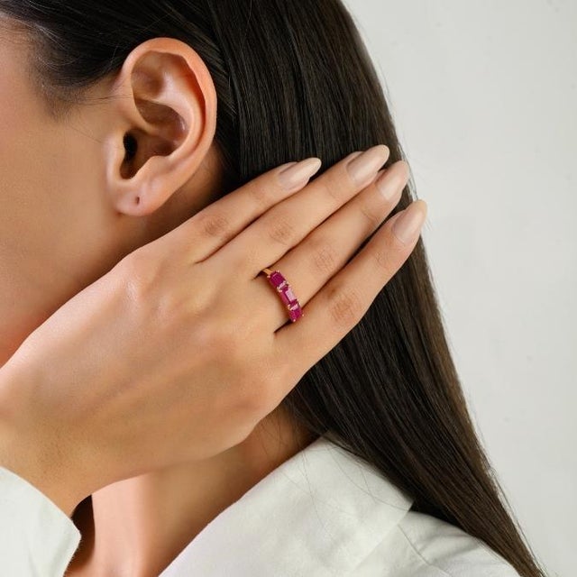 This elegant ring features 3 natural rubies totaling approximately 2.14 carats, set in rich 14k yellow gold. The ruby...