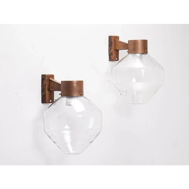 Rare model. 2 available. Outdoor wall lamps with great patina. Produced in Sweden by Fagerhults, 1960s. This piece is...