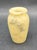 This item appears to be a small, vintage hand-carved alabaster vase featuring a creamy honey base with distinctive grey...