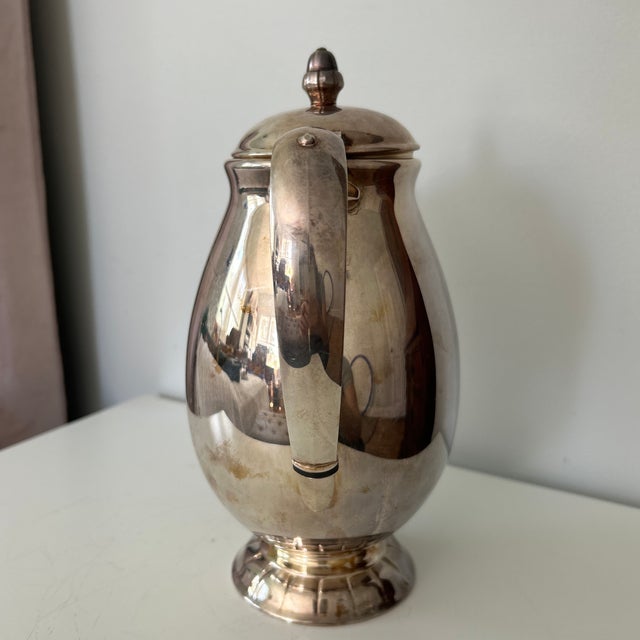 Elegant vintage silver-plated coffee pot by Empire Crafts in the Gloriana pattern. The classic pear-shaped body features a...