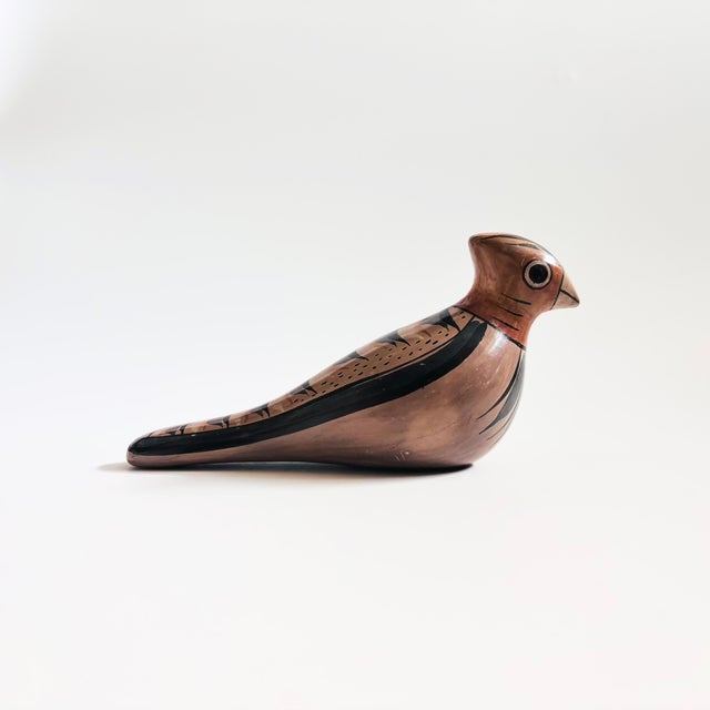 A wonderful vintage Mexican folk art pottery bird. Beautiful hand painted floral accents. Made in Mexico, signed on the base.