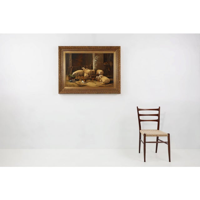 Baroque style signed painting with highly decorative gilded wooden frame from Belgium. Signed in the right corner. This...