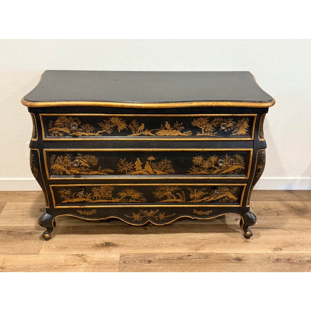 An elegant and highly decorative Nancy Corzine Chinoiserie Bombay Commode, featuring a classic serpentine bombe silhouette...