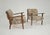 A stunning pair of vintage armchairs, mostly from the 1960s, featuring a solid wooden frame and fabric upholstery with...