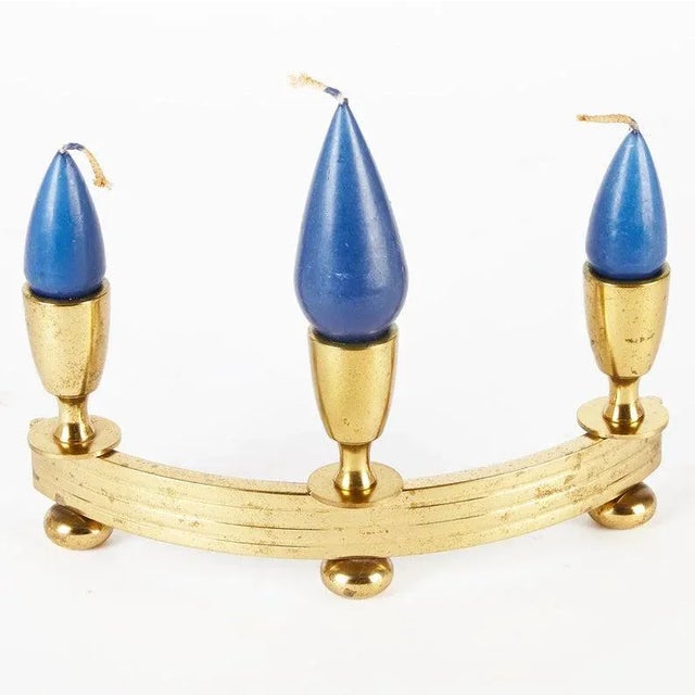 Heavy brass candelabra from the mid-century era. Shaped like a crescent; holds 3 candles. CONDITION Good vintage condition...