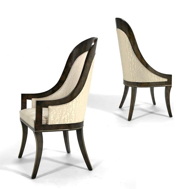 Designed by William Doezema, these elegant dining chairs by Mastercraft feature burl amboyna wood frames inlaid with brass...