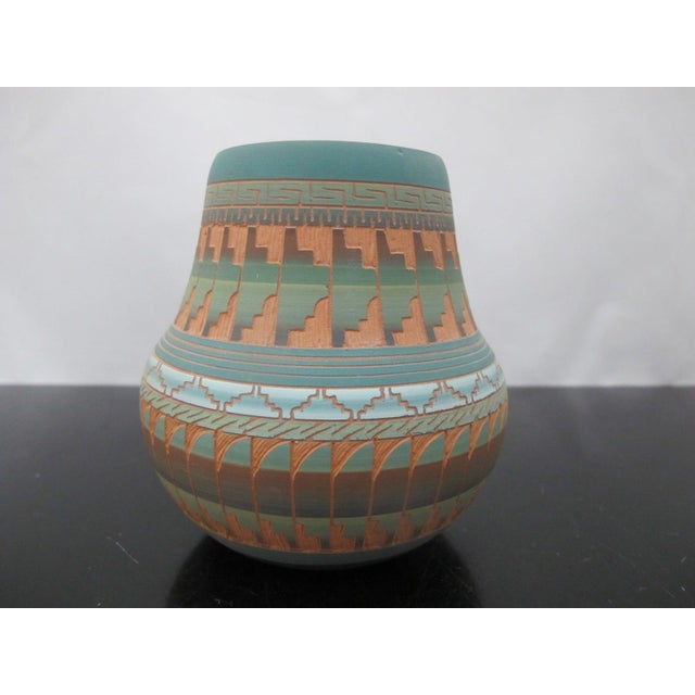 Navajo Native American pottery vase by artisan Susie Charlie. Sgrafitto vase with polychrome etched design in earth tones...