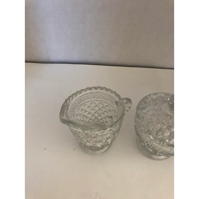 Vintage clear press glass creamer and lidded sugar set in excellent condition. Creamer is 4”H X 5”W Sugar is 3” H X 4” W