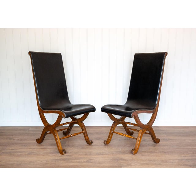 A pair of superb quality, extremely rare and very impressive spanish black leather and oak dining chairs in lovely...