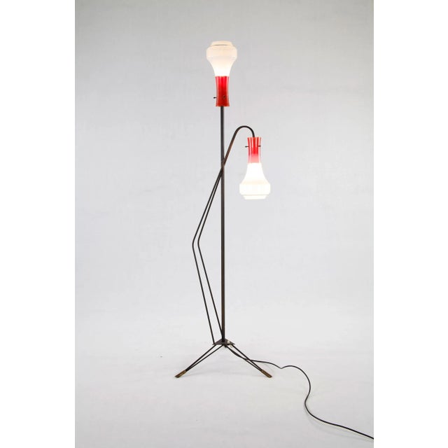 This Italian floor lamp was produced in the 1950s. It features a black lacquered iron frame, brass elements and two-tone...