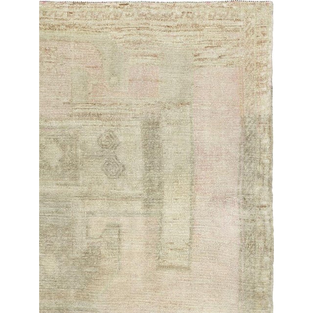 This Mid-20th century Turkish Anatolian wide gallery runner presents a softly layered composition in a restrained palette...
