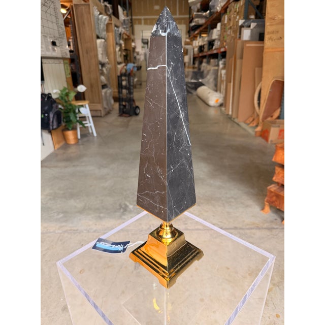 Add a bold architectural statement to your décor with this contemporary obelisk sculpture, expertly crafted from genuine...