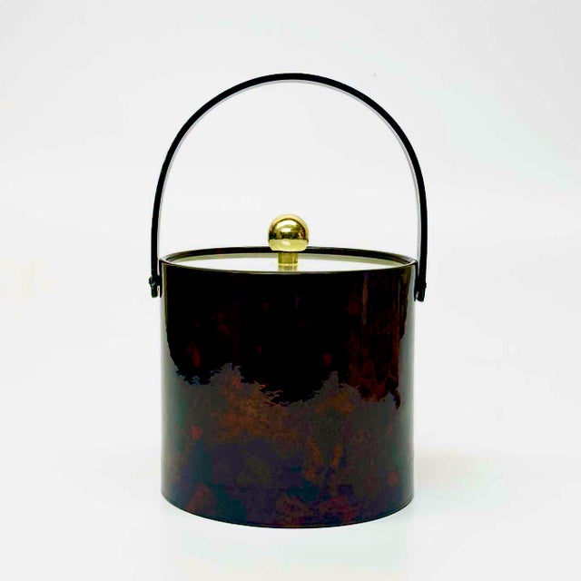 Oxblood faux-leather ice bucket. This is a beautiful 1970s oxblood brown faux leather ice bucket; featuring a cylindrical...