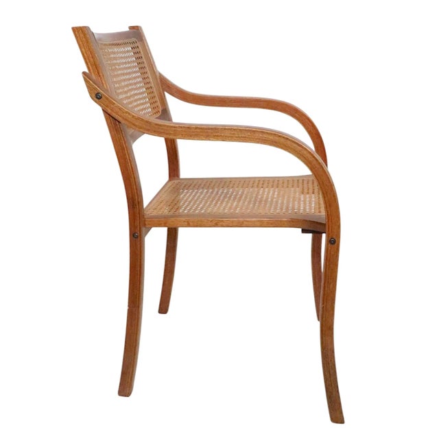 Stylish bent plywood and caned arm chair, executed in the Constructivist style, in the manner of Thonet, unsigned. This...