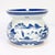 A fine antique Chinese porcelain spittoon. In the Canton pattern. Decorated in underglaze blue with a mountainous Chinese...