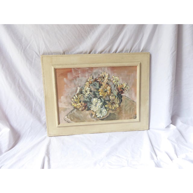 20th Century oil on canvas of a floral bouquet, signed lower right Jeannie Draper, framed in an antique white painted...