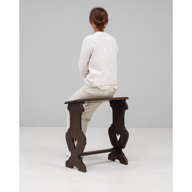 This 20th century French wooden stool features a charming hand-carved silhouette with heart-shaped cutouts, reflecting...