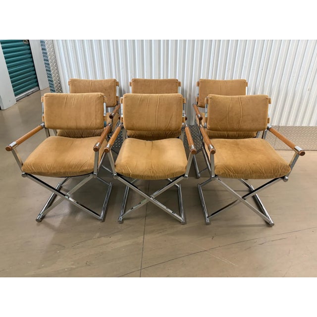 This is a stunning set of chrome and wood director's arm dining chairs. The chrome is bright and shiny. The cushions are a...