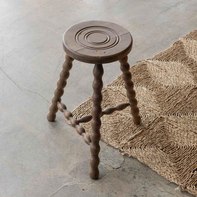 Vintage wood stool with beautiful wavy wood legs from France. Circular seat with unique carved ring detail on top....