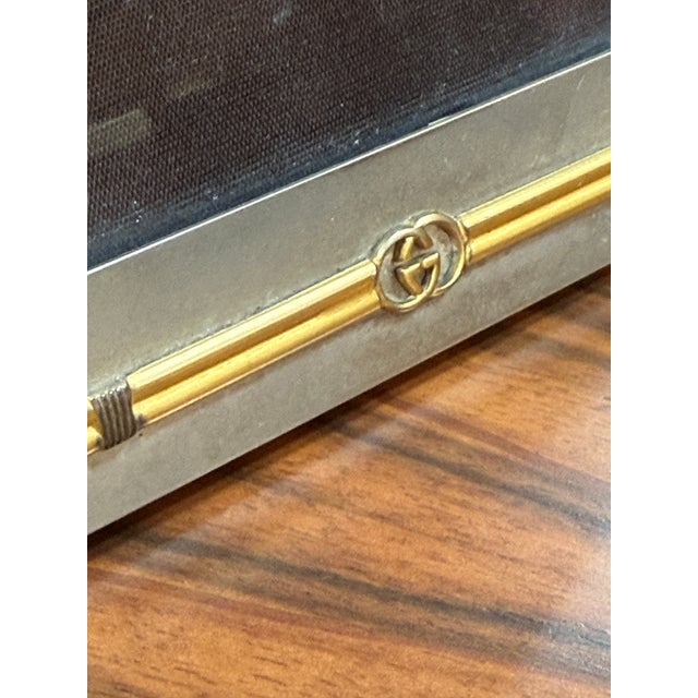 This elegant vintage Gucci photo frame features a refined design blending matte silver-tone metal with gold bamboo-style...