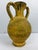 A decorative terracotta amphora urn featuring a textured Scavo-style finish with mottled yellow and brown tones. The...