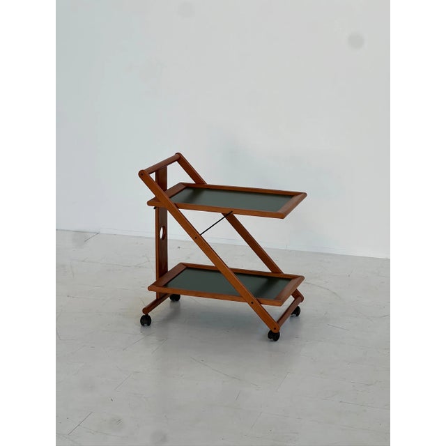 Simple and elegant elegant carrying trolley, Norda production, late 1980s. Made with a wooden structure and two shelves of...