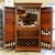 Traditional-style bar cabinet crafted in a warm wood finish with a lighted interior and mirrored back for display and...