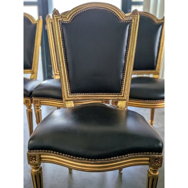 An exceptional and rare set of six authentic 19th-century French Louis XVI side chairs. These chairs feature elegantly...