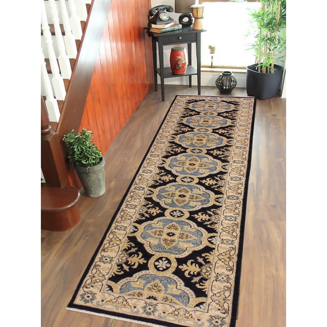 Enhance the ambiance of your home with this magnificent Persian-influenced Turkish hand-knotted rug made by skilled...
