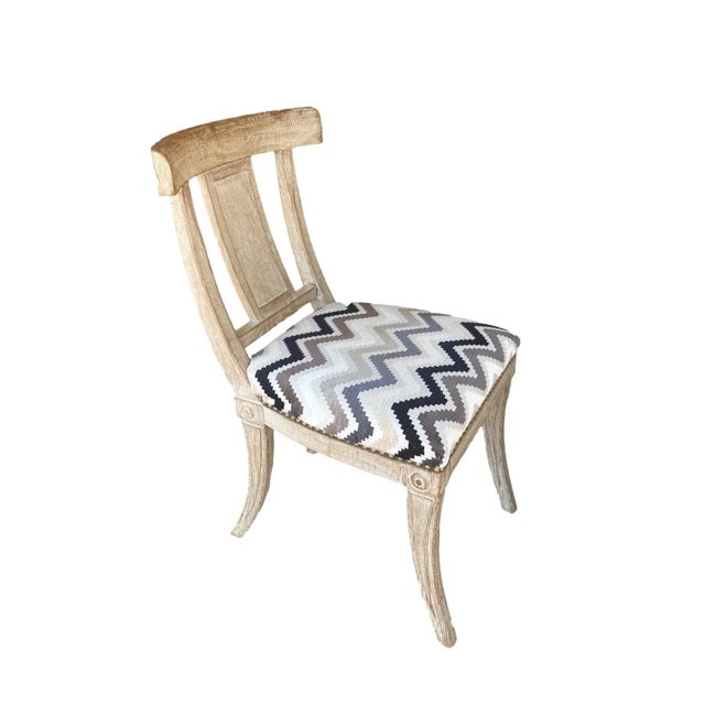 A graceful set of 4 Klismos dining side chairs with beautifully carved details on the legs, rondelles on the corners,...