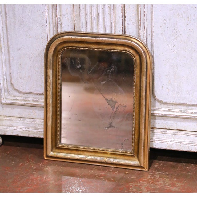 This elegant antique Louis Philippe mirror was crafted circa 1870. The rectangular frame features the classic arched top...