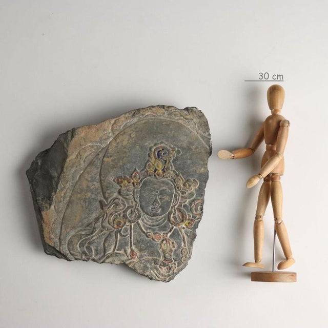 Sculpted and painted slate mani stone depicting avalokiteshvara, the bodhisattva (buddhist deity) of compassion. The...