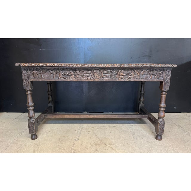 A super English 19th Century Carved Oak Table having the nice feature of a drawer in each end. Lovely carvings depicting...