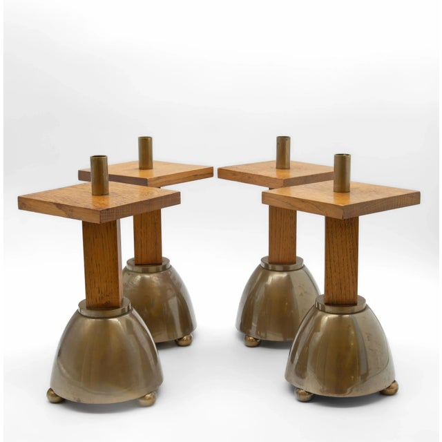 A set of four Brutalist brass and solid oak candlesticks. Circa 1970. There are a few signs of use to the finish as...