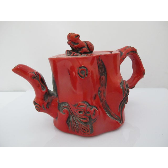 Chinese red lacquer molded teapot, organic in design, made to look like a hollowed tree stump. Striking bright red color...