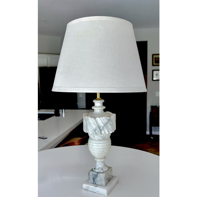 Single smaller scale vintage Italian Neoclassical style table lamp made from hand-carved alabaster, featuring a urn-shaped...