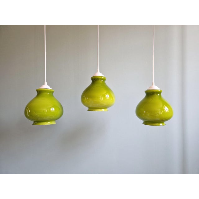 Vintage green opaline pendant light from the 1960s-70s. --> 4 suspensions available. Each of the lamps has been re-...