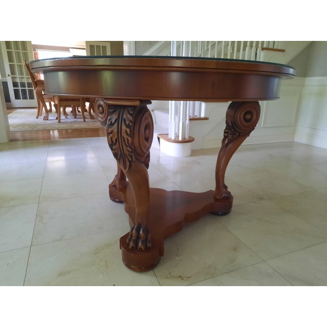 Hand-Crafted Italian Table. Charles X style round table with a walnut veneer top and base. Three solid maple legs with an...