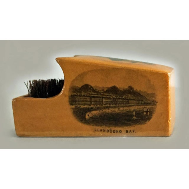Mauchline ware pen wipe decorated with transfer printed scenes of the Llandudno pier, Llandudno bay and St. Tudnos Church...